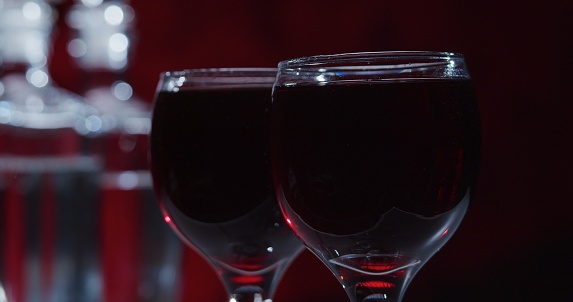 Red wine on the red background. Close-up
