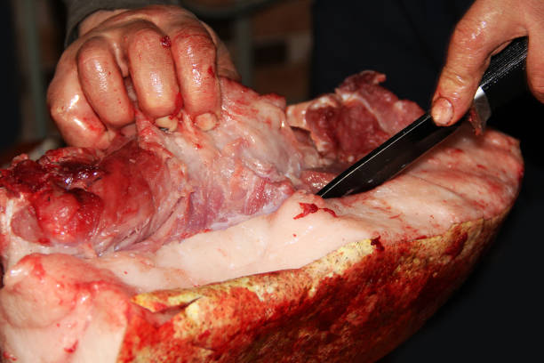 istock Man cuts raw meat. Pork. Meat and blood 1277149727