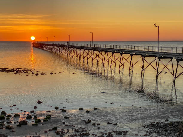 istock Fiery golden sun sets at end of Ceduna Jetty 1277150052