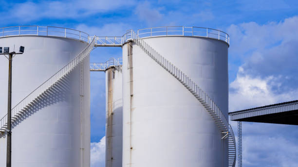 istock White storage fuel tanks against cloudy in blue sky 1277152458
