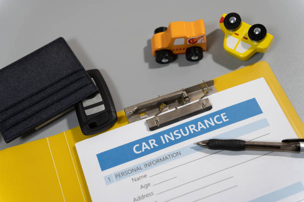 toy car, key, pen, document, car insurance concept on table