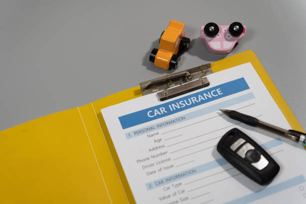 istock toy car, key, pen, document, car insurance concept on table 1277153121