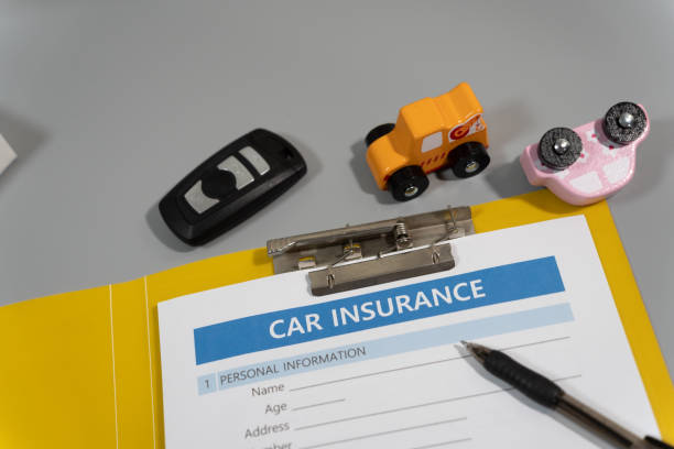 istock toy car, key, pen, document, car insurance concept on table 1277153123