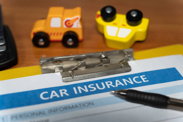 istock toy car, key, pen, document, car insurance concept on table 1277153126
