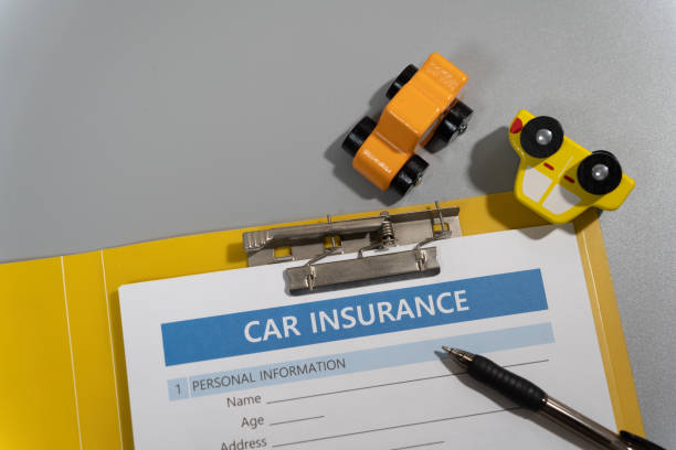 istock toy car, pen, document, car insurance concept on table 1277153130