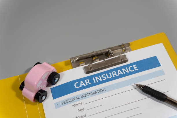 istock toy car, pen, document, car insurance concept on table 1277153136