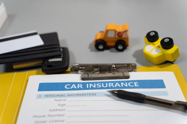 istock toy car, key, pen, document, car insurance concept on table 1277153138