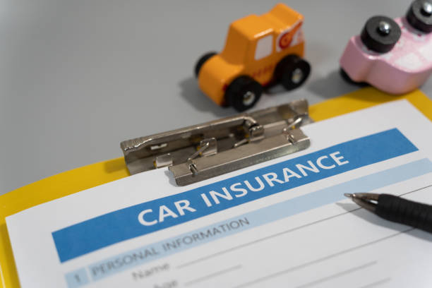 istock toy car, pen, document, car insurance concept on table 1277153151
