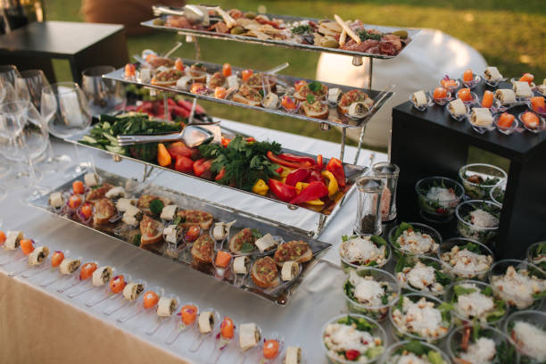 istock Big table with different luxury snacks on the deluxe party outdoors in sunset 1277153484