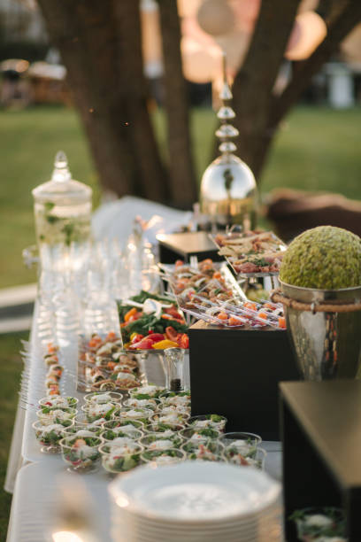 istock Big table with different luxury snacks on the deluxe party outdoors in sunset 1277153523