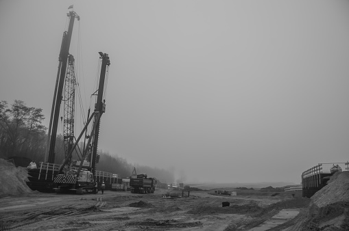 Nuth, the Netherlands, - March 18, 2016. Construction site for a new highway bridge situated in the morning mist.