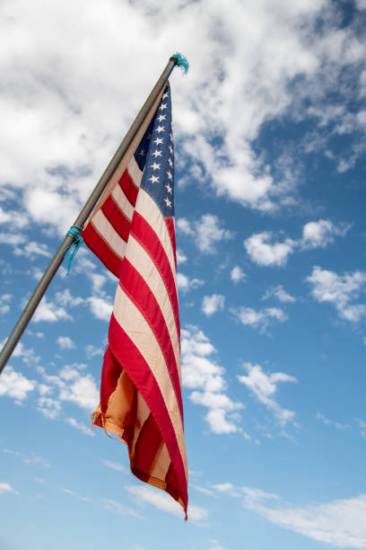 istock American flag waving in the sky 1277157691