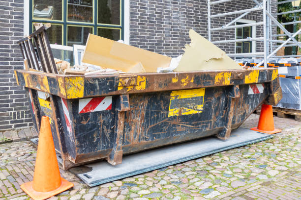 istock Filled waste container in an old street on a home renovation construction site 1277158245