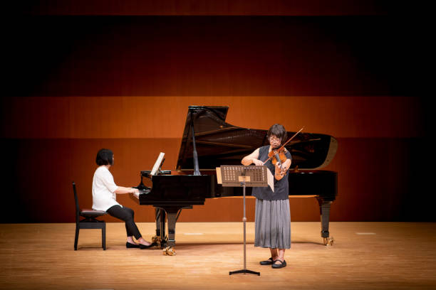 istock Violinist and pianist playing at classical concert 1277159332