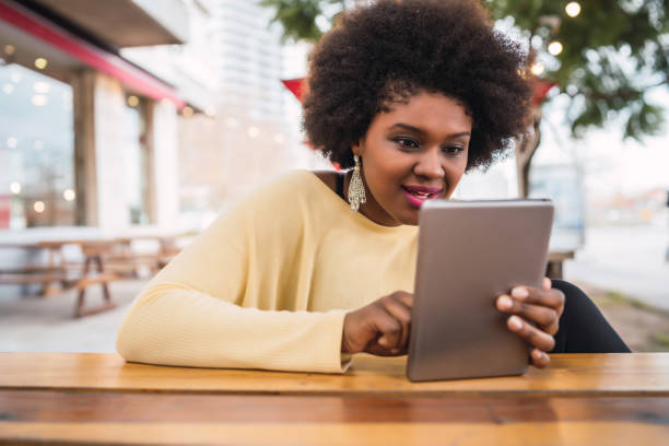 istock Afro american latin woman using digital tablet 1277161145