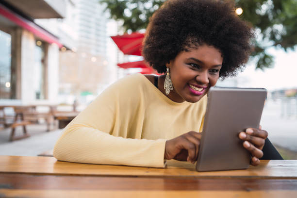istock Afro american latin woman using digital tablet 1277161152