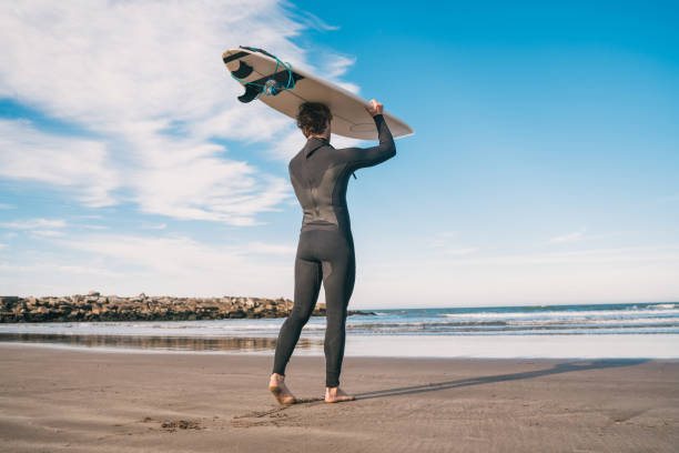 istock Young surfer holding up his surfboard. 1277161160