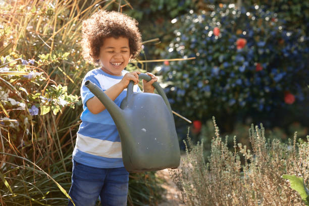 istock Happy boy gardening outdoors 1277161428