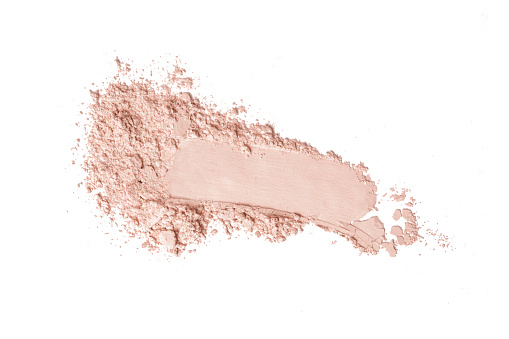 Crushed pink eyeshadow on a white background.
