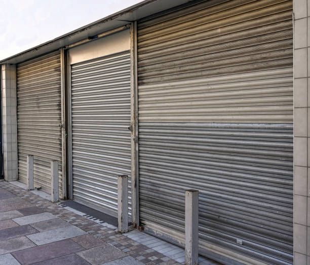 istock Steel roller shutters on the front of a business which has closed down 1277161715