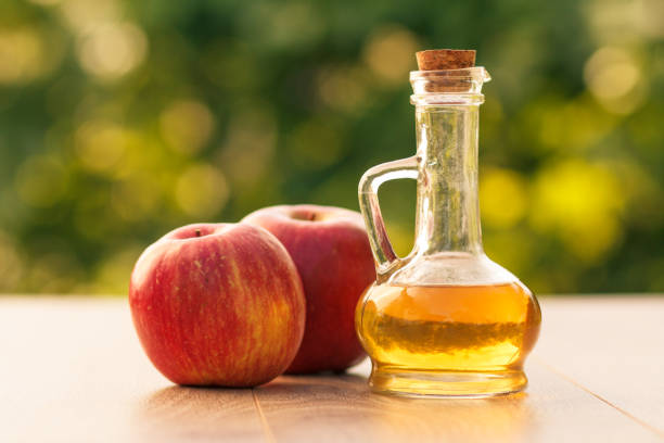 istock Apple vinegar in glass bottle and fresh red apple 1277163237