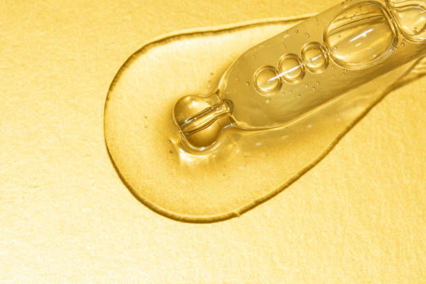 istock macro of pipette with pouring liquid on gold background 1277163417