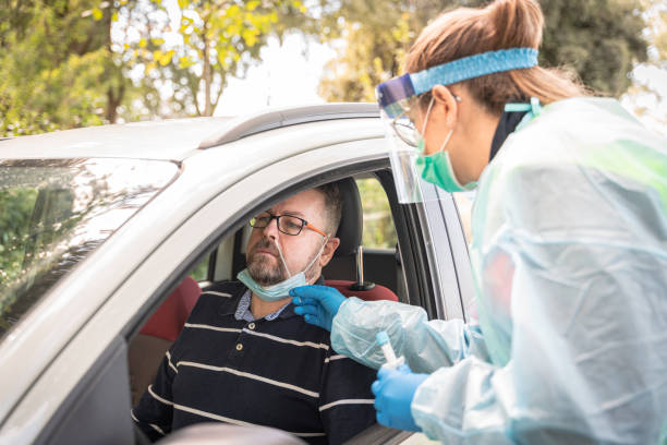 istock paramedic making a covid swab to a driver directly from his car 1277163489