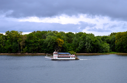 White paddle wheel boat on the Mississippi River between Minnesota and Wisconsin