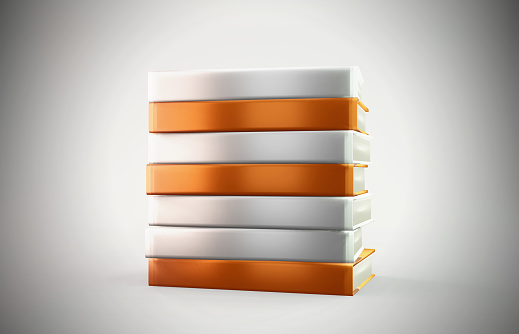 Orange and white empty books stand on an grey background. Horizontal composition with copy space. Reading and learning concept.