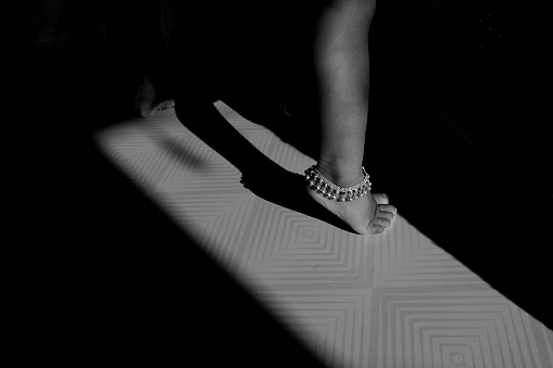 a girl anklet chain isolated morning sunlight in house