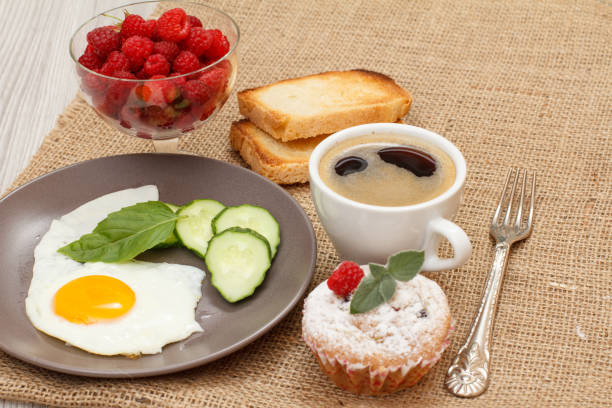 istock Plate with fried egg, cup of coffe and berries. Meal for breakfast 1277169254