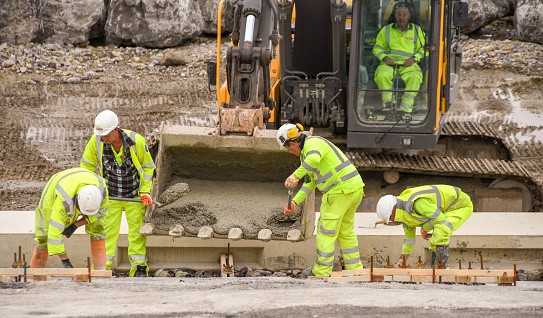 Porthcawl, Wales - June 2018: Construction operatives working on the redevelopment of the seafront in the centre of the town's promenade