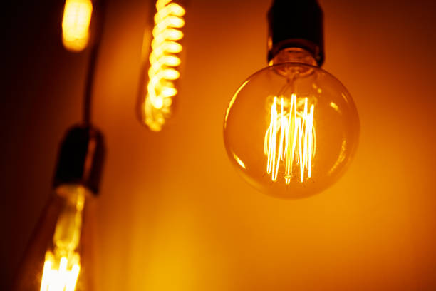 istock Set of a vintage light bulb on orange background, soft focus. Glowing edison bulb 1277170488