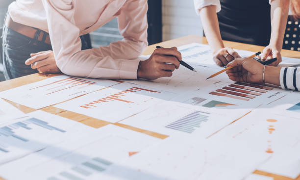business planning work images Business people hand pointing at business document during discussion at meeting. Business people hand pointing at business document during discussion at meeting. business plan stock pictures, royalty-free photos & images