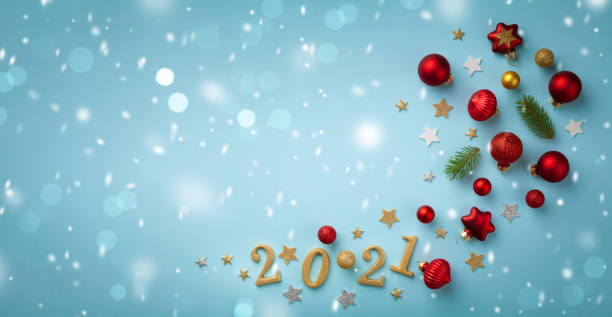 istock Creative flat lay composition with Christmas tree ornaments, numbers 2021 and holiday decorations on blue background top view. New Year greeting card. 1277172981