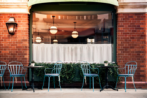 Empty coffee and restaurant terrace with tables and chairs in london indie and hipster style