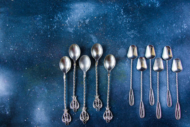 istock Silverware, silver vintage spoon background, spoon set on the dark background 1277176185