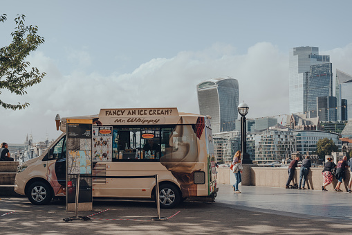 London, UK - August 25, 2020: Mr. Whippy van by Tower Bridge, London. Mr Whippy originated in the United Kingdom in 1958, selling soft serve ice cream from mobile vans.