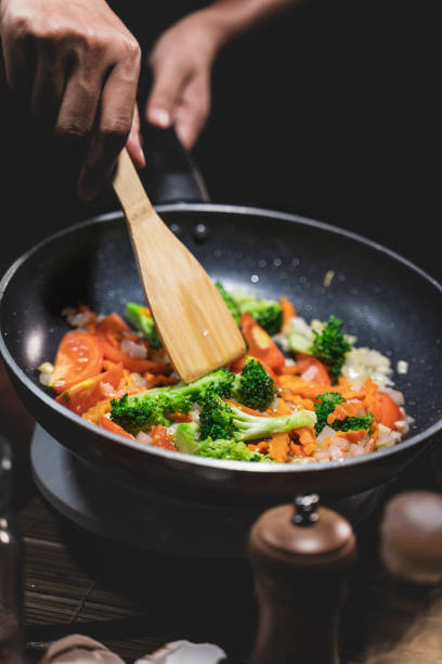 istock Close up,Young women cooking fried mixed vegetables. 1277178243