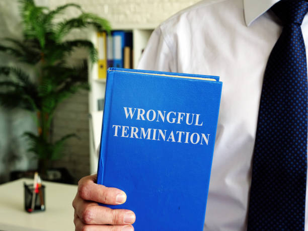 istock Wrongful termination. The employee holds a book in his hands. 1277178419