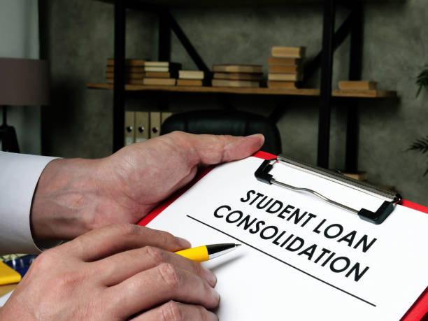 istock Man fills out the form for student loan consolidation. 1277178984