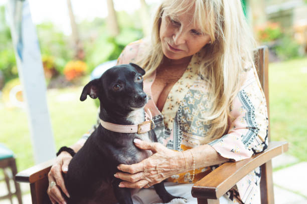istock Senior woman hugging her small pet dog 1277181136