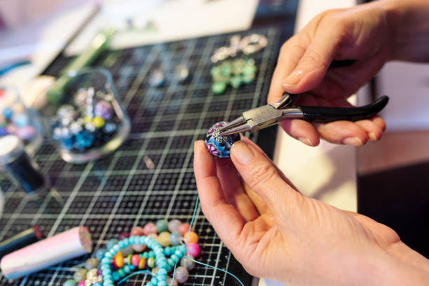istock woman making craftsmanship, polymer clay and silver jewellery in the workshop. 1277181870