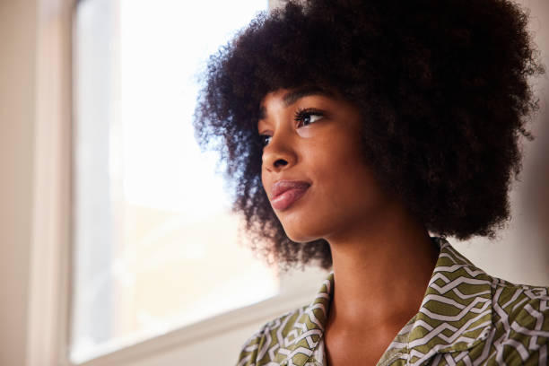 istock Young woman leaning against a wall deep in thought 1277182612