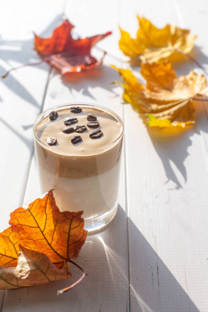 istock Traditional Korean caffeinated milk drink, Dalgona coffee in a glass with coffee beans on a white board background. 1277184765