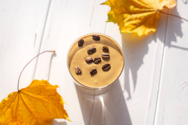 istock Traditional Korean caffeinated milk drink, Dalgona coffee in a glass with coffee beans on a white board background. 1277184780