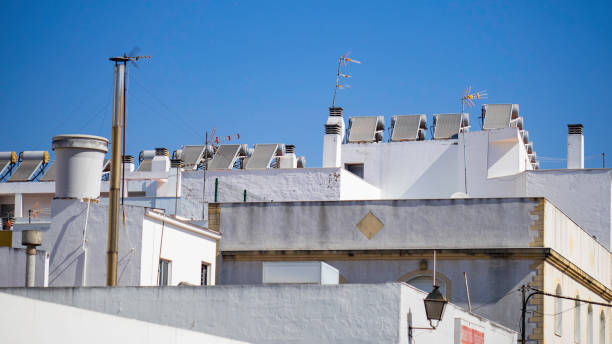 istock Rooftops with TV antennas and solar panels 1277185327