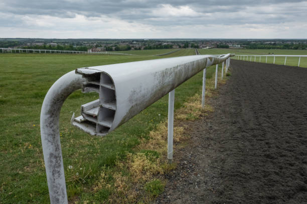 Shallow focus of a broken plastic barrier seen on a equine racecourse track.