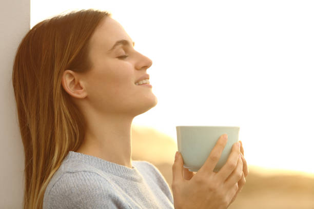istock Relaxed woman drinking coffee resting on the beach 1277185401