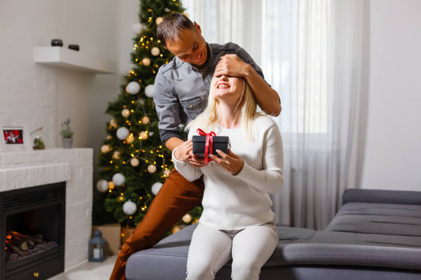 istock Young happy couple near a Christmas tree 1277185509
